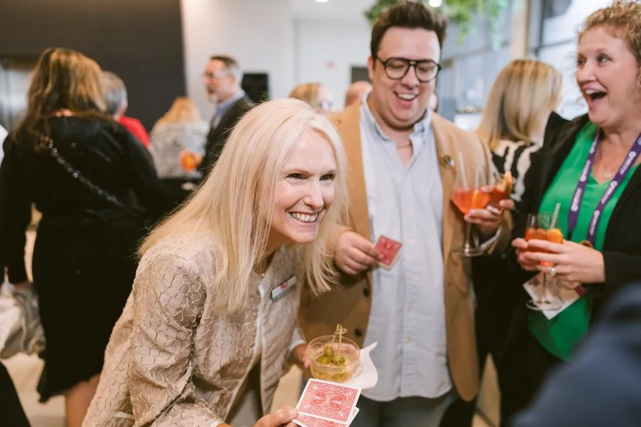 Brian Masters performing strolling magic for guests at a corporate mixer